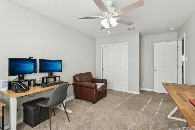 carpeted office with a ceiling fan, baseboards, and visible vents