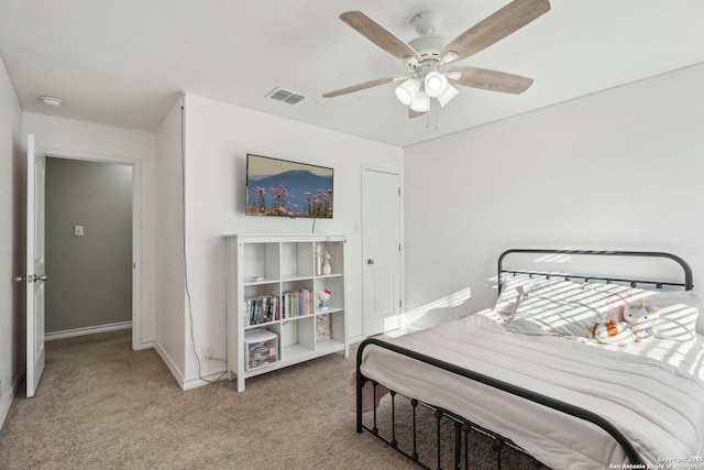 bedroom featuring light colored carpet, baseboards, visible vents, and ceiling fan