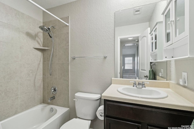 full bathroom with vanity, visible vents, a textured wall, toilet, and shower / tub combination