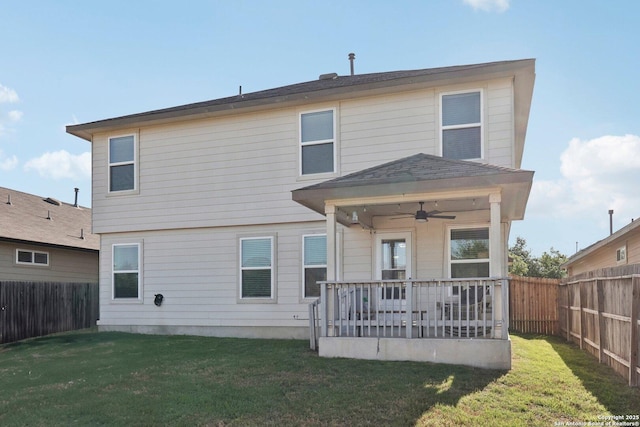 back of house with a fenced backyard, ceiling fan, a yard, and a patio area