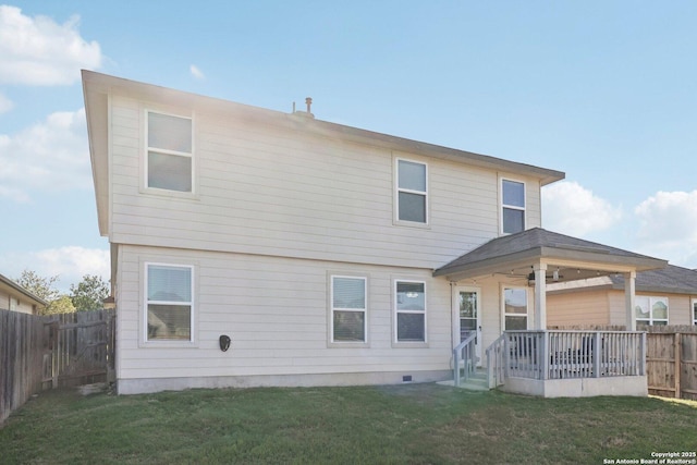 rear view of house with a lawn, a fenced backyard, ceiling fan, and crawl space