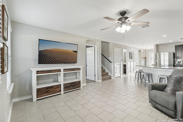 living area featuring visible vents, baseboards, ceiling fan, stairway, and recessed lighting