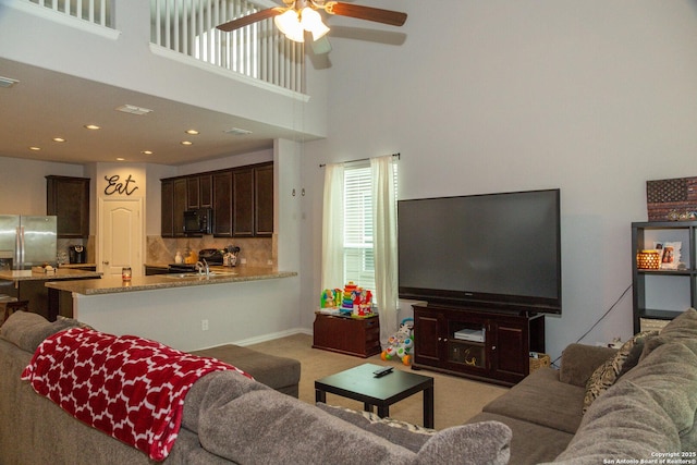 8220 Robin Gate, Selma, TX 78154 - living area with light colored carpet, a ceiling fan, baseboards, recessed lighting, and a towering ceiling