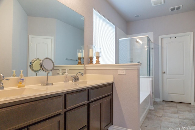 8220 Robin Gate, Selma, TX 78154 - bathroom featuring visible vents, a sink, double vanity, and a shower stall