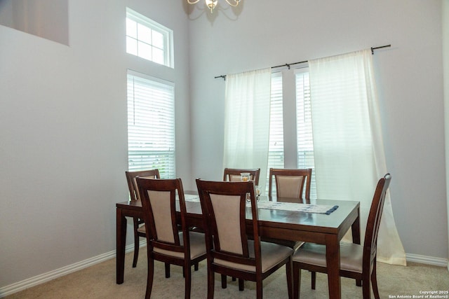 8220 Robin Gate, Selma, TX 78154 - dining room with baseboards, light carpet, a towering ceiling, and a chandelier