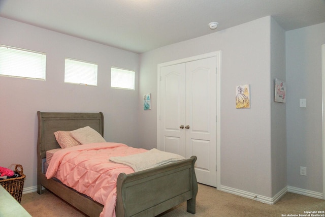 8220 Robin Gate, Selma, TX 78154 - bedroom featuring a closet, baseboards, and light carpet