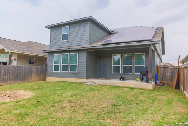 8220 Robin Gate, Selma, TX 78154 - rear view of property featuring a lawn, a patio, solar panels, and a fenced backyard