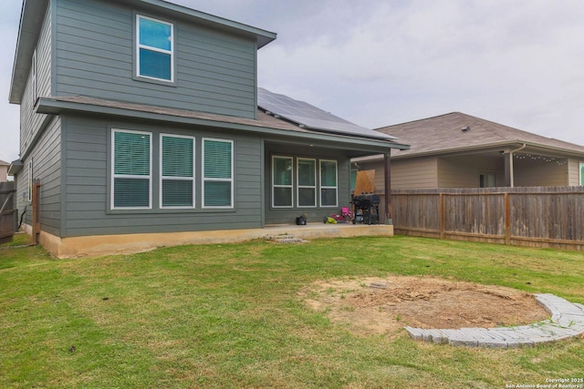 8220 Robin Gate, Selma, TX 78154 - back of property with a yard, fence private yard, roof mounted solar panels, and a patio area