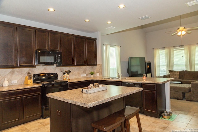 8220 Robin Gate, Selma, TX 78154 - kitchen featuring a healthy amount of sunlight, black appliances, a peninsula, and open floor plan