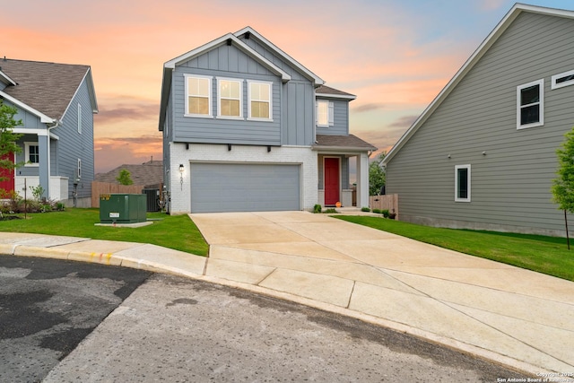 15011 Wychwood, San Antonio, TX 78233 - view of front of house featuring a garage, brick siding, central AC unit, board and batten siding, and a yard