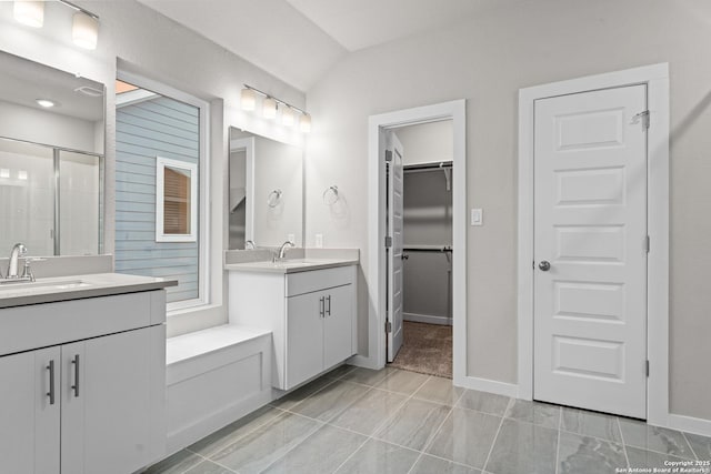 15011 Wychwood, San Antonio, TX 78233 - full bath with two vanities, a walk in closet, a shower stall, and a sink