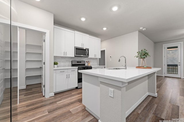 15011 Wychwood, San Antonio, TX 78233 - kitchen featuring a sink, a center island with sink, stainless steel appliances, and dark wood-style floors