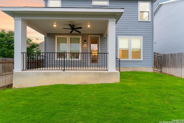15011 Wychwood, San Antonio, TX 78233 - entrance to property with a lawn, ceiling fan, and fence