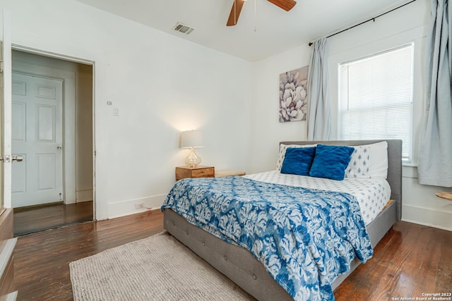 bedroom featuring visible vents, baseboards, ceiling fan, and hardwood / wood-style flooring