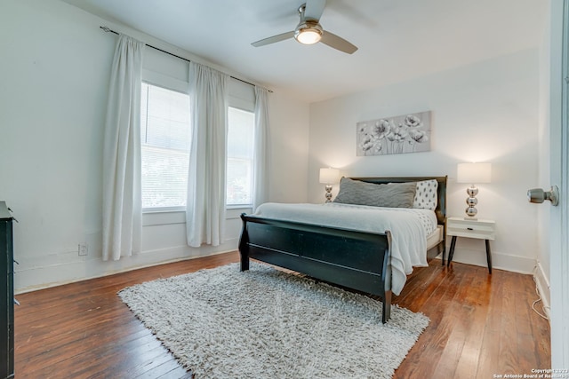 bedroom with ceiling fan and hardwood / wood-style flooring