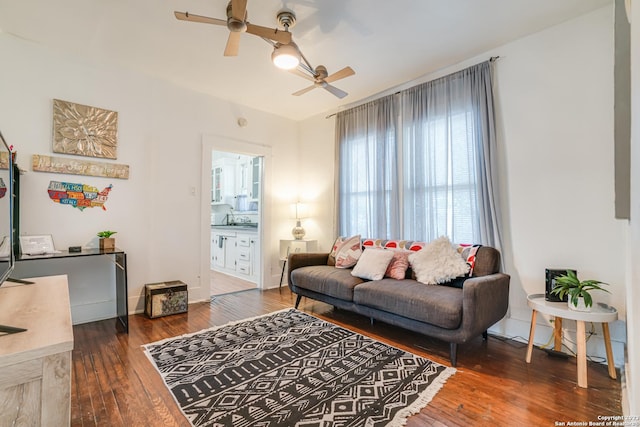 living room with a ceiling fan and hardwood / wood-style flooring