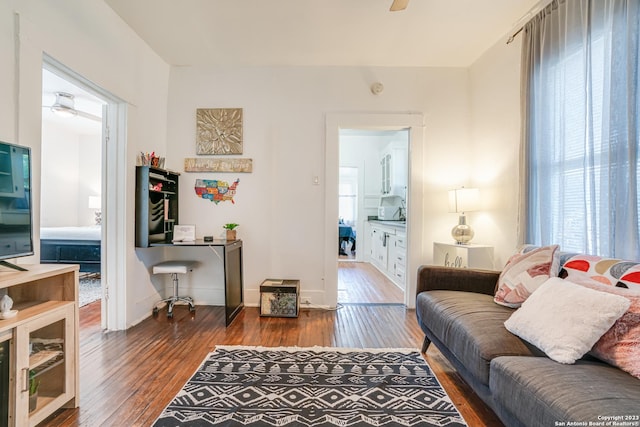 living room with baseboards, ceiling fan, and hardwood / wood-style floors