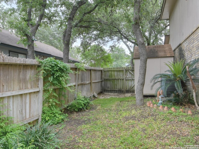 8811 Silent Strm, San Antonio, TX 78250 - view of yard with a fenced backyard, an outbuilding, and a storage shed
