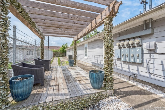 wooden deck with central AC unit, fence, and a pergola