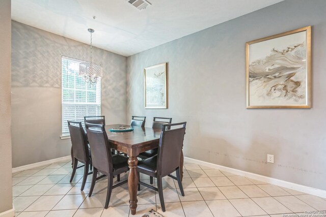 dining room featuring an inviting chandelier, baseboards, light tile patterned floors, and visible vents