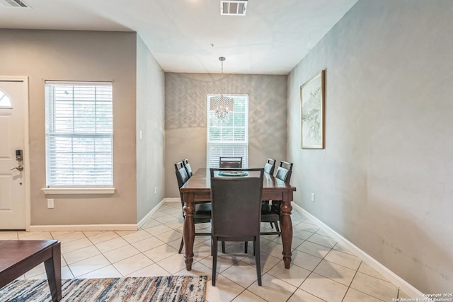 dining room with light tile patterned flooring, baseboards, and visible vents