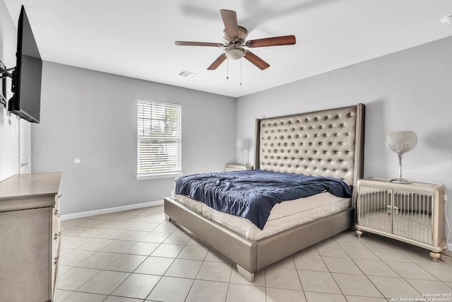 bedroom featuring visible vents, baseboards, ceiling fan, and light tile patterned flooring