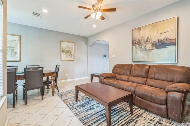 living room featuring visible vents, a ceiling fan, recessed lighting, arched walkways, and light tile patterned floors