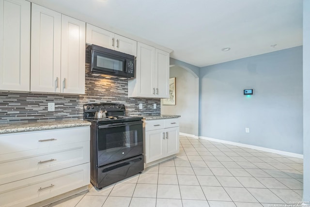 kitchen with decorative backsplash, baseboards, white cabinetry, arched walkways, and black appliances