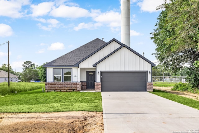 25 Main, Hempstead, TX 77445 - modern farmhouse style home featuring a garage, a front yard, brick siding, a shingled roof, and concrete driveway