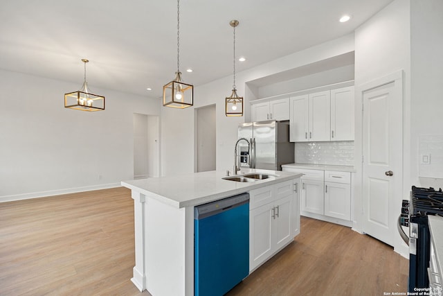 25 Main, Hempstead, TX 77445 - kitchen featuring light wood-type flooring, a sink, tasteful backsplash, and stainless steel appliances