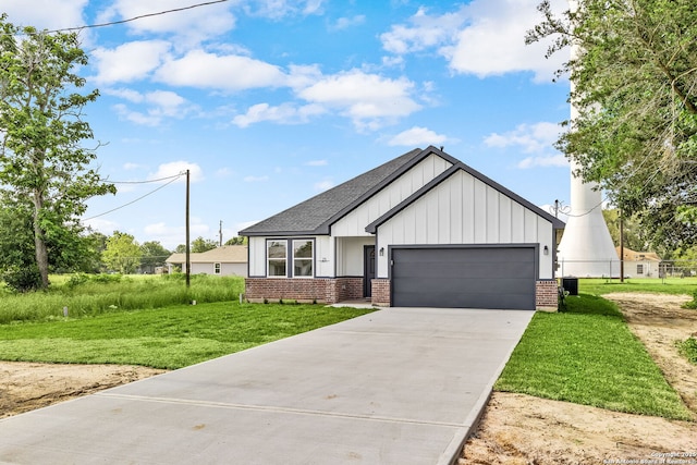 25 Main, Hempstead, TX 77445 - modern farmhouse with a garage, a front yard, brick siding, board and batten siding, and driveway