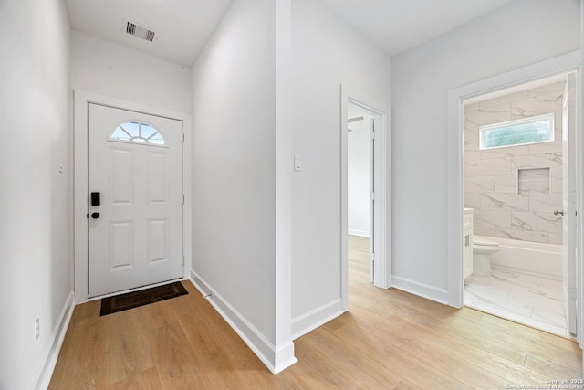 25 Main, Hempstead, TX 77445 - entrance foyer featuring baseboards, plenty of natural light, light wood finished floors, and visible vents