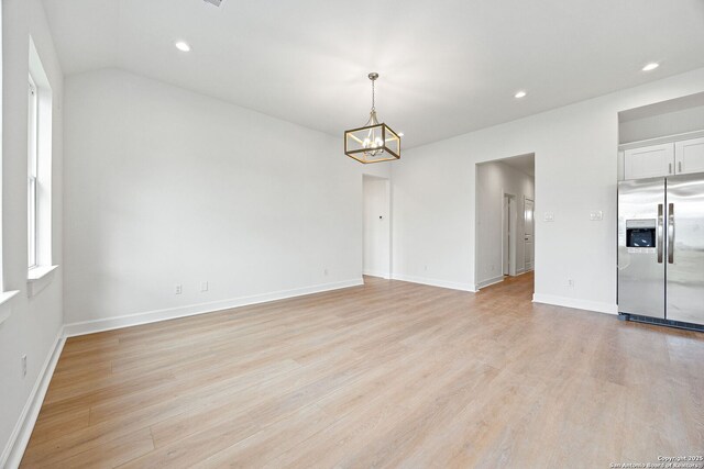 25 Main, Hempstead, TX 77445 - empty room with recessed lighting, baseboards, an inviting chandelier, and light wood-type flooring