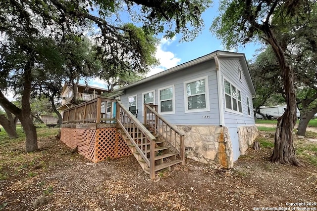 back of property with stairway and a wooden deck