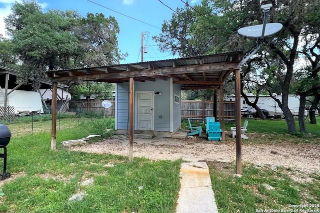 exterior space with fence and an outbuilding