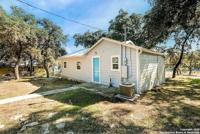 rear view of house featuring central AC unit