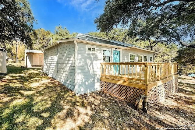rear view of house with a wooden deck
