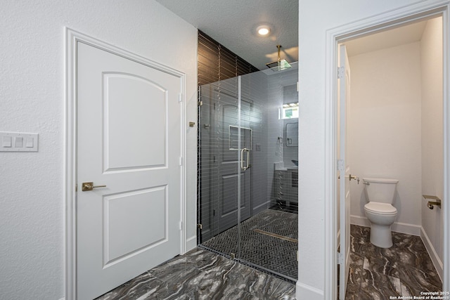 full bathroom with baseboards, a stall shower, toilet, and marble finish floor