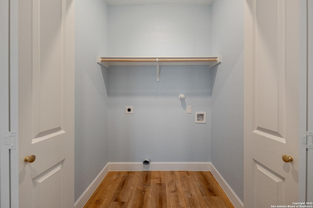 clothes washing area with laundry area, wood finished floors, baseboards, electric dryer hookup, and washer hookup