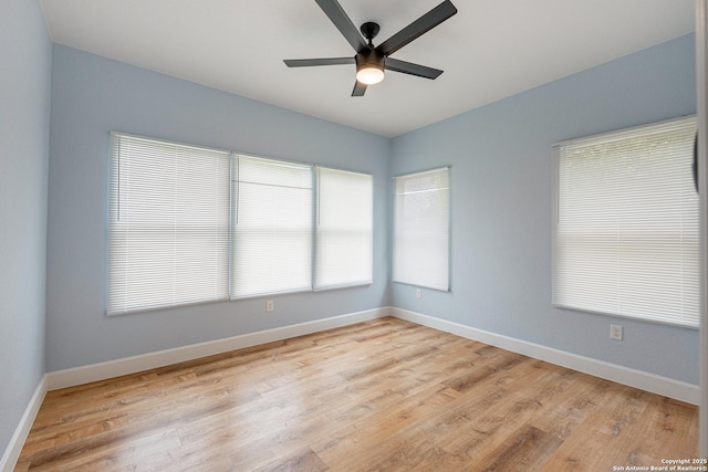empty room with ceiling fan, baseboards, and light wood-type flooring