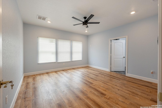spare room with visible vents, wood finished floors, baseboards, recessed lighting, and a ceiling fan