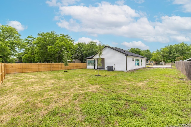 view of yard with cooling unit and a fenced backyard