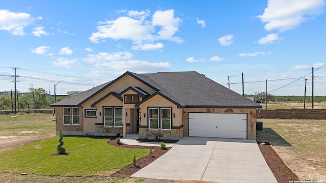 view of front of home with a garage, a front lawn, fence, a shingled roof, and driveway
