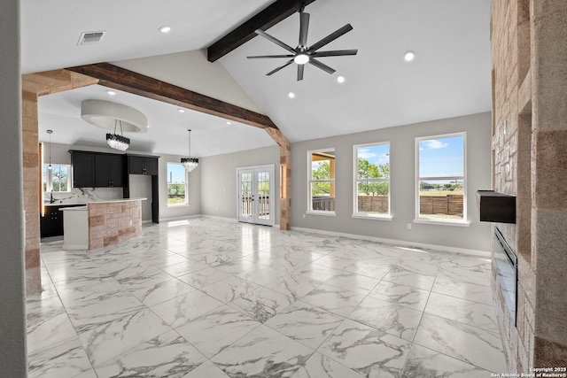 unfurnished living room with visible vents, beamed ceiling, baseboards, recessed lighting, and ceiling fan with notable chandelier