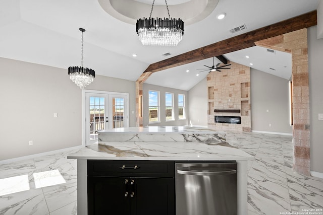 kitchen with dark cabinets, a large fireplace, ceiling fan with notable chandelier, open floor plan, and vaulted ceiling with beams