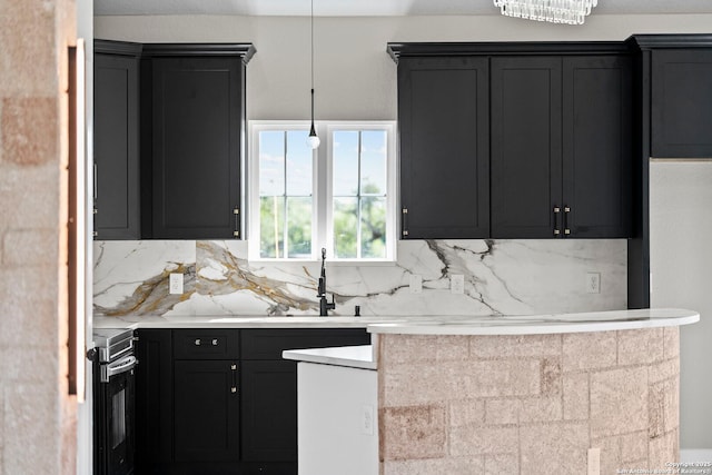 kitchen with backsplash, electric range, light countertops, a sink, and dark cabinets
