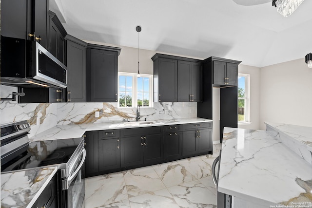 kitchen with a sink, tasteful backsplash, stainless steel appliances, and a wealth of natural light