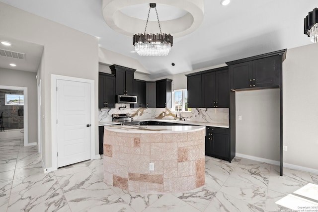 kitchen featuring light countertops, dark cabinets, stainless steel appliances, baseboards, and visible vents