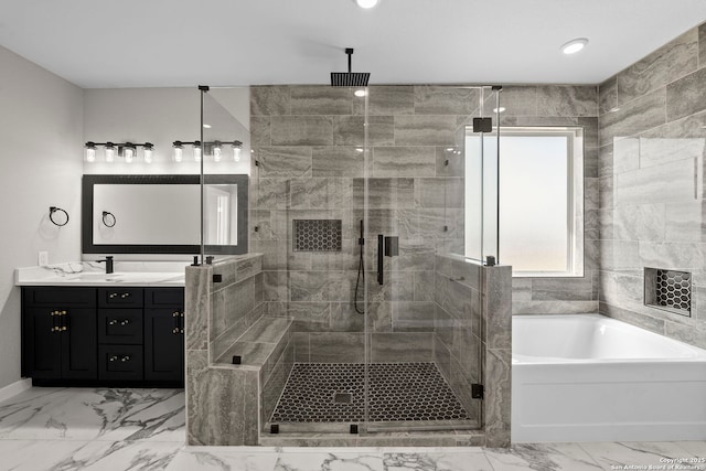bathroom with marble finish floor, a stall shower, a bath, and vanity