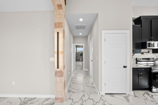 hallway featuring baseboards, visible vents, recessed lighting, and marble finish floor